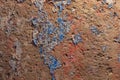 shabby peeled white, blue and red paint layers on concrete surface - flat background and texture Royalty Free Stock Photo