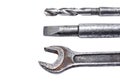 Shabby spanner, chisel and drill closeup on white background Royalty Free Stock Photo