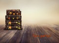 Shabby Vintage Ancient Suitcases. Background of wooden boards. Concept travel with the inscription Have a good trip Royalty Free Stock Photo