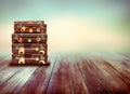 Shabby Vintage Ancient Suitcases. Background of wooden boards.