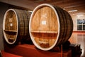 Shabo, Ukraine - June 29, 2021: Old aged traditional wooden barrels with wine in a vault lined up in cool and dark cellar in Italy