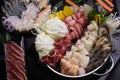 Shabu Shabu or Sukiyaki, a popular dish of pork, beef, shrimp, squid, seafood and fresh vegetables. Placed on a table with a Royalty Free Stock Photo