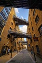 Shad Thames in London, UK. Historic Shad Thames is an old cobbled street known for its restored overhead bridges and walkways