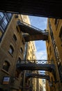 Shad Thames in London, UK. Historic Shad Thames is an old cobbled street known for it`s restored overhead bridges and walkways Royalty Free Stock Photo