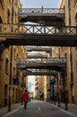 Shad Thames in London, UK. Historic Shad Thames is an old cobbled street known for it`s restored overhead bridges and walkways Royalty Free Stock Photo
