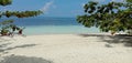 View above the lagoon with its turquoize color and the beach, shade of blue between sea and sky