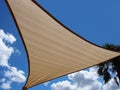 A shade sail against a blue sky