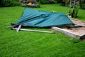 A shade of wooden poles fell on the sandpit in the family garden with a strong wind and rot of wood. the accident was avoided with Royalty Free Stock Photo