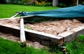 A shade of wooden poles fell on the sandpit in the family garden with a strong wind and rot of wood. the accident was avoided with Royalty Free Stock Photo