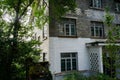 Shaded dilapidated brick building of abandoned 1960s` factory