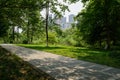 Shaded path in verdant city at sunny summer noon Royalty Free Stock Photo