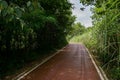 Shaded red-painted way in cloudy summer afternoon Royalty Free Stock Photo