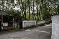 Shaded road with slogans on wall in abandoned 1960s` factory