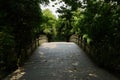 Shaded stone arch bridge in sunny summer