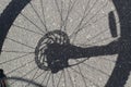 Shadow on the asphalt of a Bicycle wheel with disc brakes Royalty Free Stock Photo