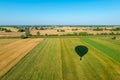 The shadow of a balloon flying over cultivated fields with a view of the cloudless sky Royalty Free Stock Photo