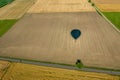 The shadow of a balloon flying over cultivated fields with a view of the roads Royalty Free Stock Photo