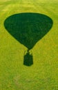 The shadow of a balloon flying over a green meadow Royalty Free Stock Photo