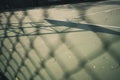 A shadow of basketball hoop on outdoor basketball court