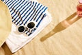 Shadow of beer glass and bottle on warm sand with beach stuffs. Chilling on warm summer day with cool drink Royalty Free Stock Photo