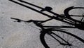 Shadow of bicycle projected onto asphalt in the sun. conceptual abstract image for travel, sport