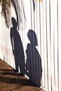 Shadow of a boy with mother at a wooden fence Royalty Free Stock Photo