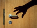 Shadow of a burglar`s arm trying to enter a house Royalty Free Stock Photo