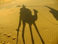 Shadow of a camel with tourist on a sand dunes, Thar desert, Ind Royalty Free Stock Photo