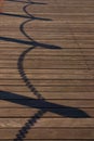 Shadow of chain fence on the old wood bridge Royalty Free Stock Photo