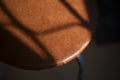 Shadow on a chair. Artificial leather in furniture. Upholstery on the stool