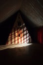 shadow of a circus tent projected on a wall