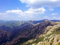 The shadow of the cloud is on the rocks in the mountains of Bulgaria against the blue sky with white clouds Royalty Free Stock Photo
