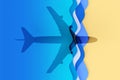 Shadow of a commercial airplane projected on a paper craft cutting beach having blue waves and white foam Royalty Free Stock Photo