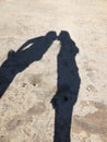 Shadow of couple on asphalt walking with hands up. Concept of relationship. Shadows of couple in love on a walk. Couple Royalty Free Stock Photo