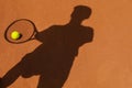 Shadow of female tennis player on clay court ball Royalty Free Stock Photo