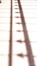 Shadow of fence with pointing arrows or spearhead