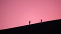 Shadow figures climbing Dune de Pilat at sunset in France Royalty Free Stock Photo