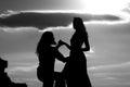 Shadow figures of man and woman holding hands. Love and relations. Silhouettes of love couple man and woman at rock