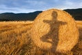 Shadow of a girl doing yoga on the bale of hay