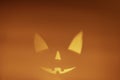 Shadow of halloween scary pumpkin face on orange paper background Royalty Free Stock Photo