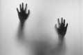 Shadow hands of the Man behind frosted glass.Blurry hand abstraction.Halloween background.Black and white picture Royalty Free Stock Photo