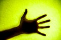 Shadow hands of the Man behind frosted glass. Royalty Free Stock Photo