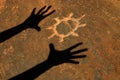 Shadow of Hands Worshipping Sun Petroglyph Royalty Free Stock Photo