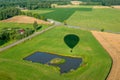 The shadow of a hot air balloon flying over fields and meadows Royalty Free Stock Photo