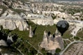 The shadow of a hot air balloon shades a landscape of fairy chimneys at Pasabagi near Zelve in Turkey. Royalty Free Stock Photo