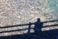 Shadow of an individual on a bridge looking at the water Royalty Free Stock Photo