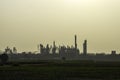 Shadow of industrail factory plant with green fields Royalty Free Stock Photo