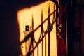 the shadow of the lattice on the old wall in the rays of the setting sun Royalty Free Stock Photo