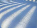 Shadow lines falling diagonally on snow surface, winter landscape texture. pattern, natural abstract background Royalty Free Stock Photo