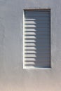 Shadow on a louvered window Royalty Free Stock Photo